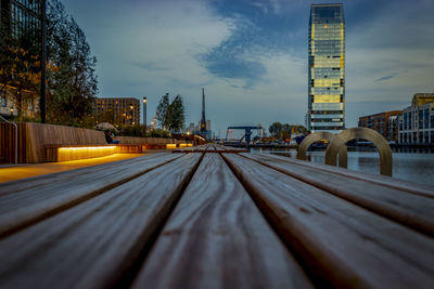 Surface level of bridge against sky in city