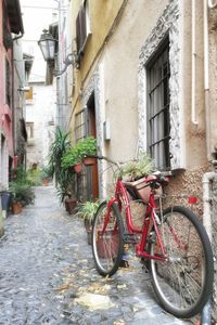 Bicycle parked against residential buildings