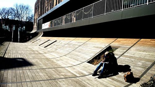 Man sitting in front of built structure