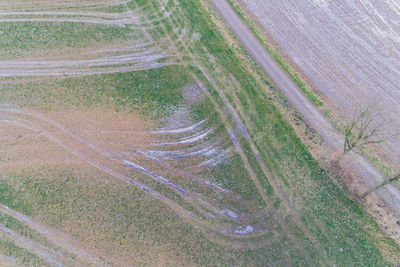 High angle view of tire tracks on road