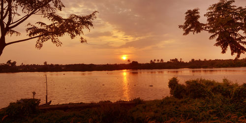 Scenic view of lake against sky during sunset