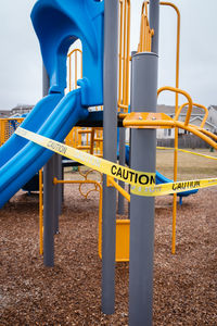 Close-up of playground against buildings