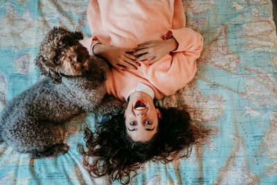 Portrait of woman with dog at home