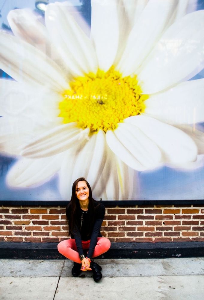 one person, sitting, young adult, front view, portrait, young women, beauty, full length, casual clothing, outdoors, yellow, one woman only, leisure activity, only women, one young woman only, beautiful woman, women, smiling, steps, day, headband, real people, adults only, flower, nature, fragility, people, adult