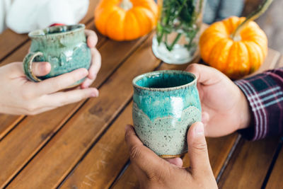 Cropped hands of woman holding drink