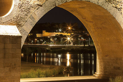 Reflection of illuminated bridge in water