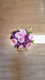High angle view of pink roses in vase on table