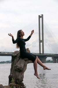 White woman stands near a beautiful lake