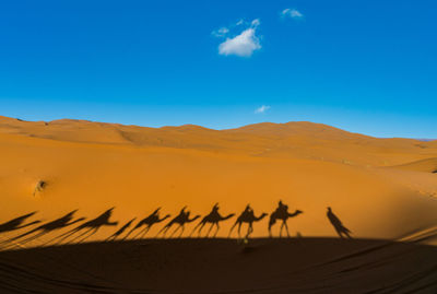 Scenic view of desert against blue sky