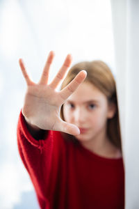 Portrait of girl gesturing stop sign