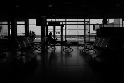 Silhouette people walking in corridor of building