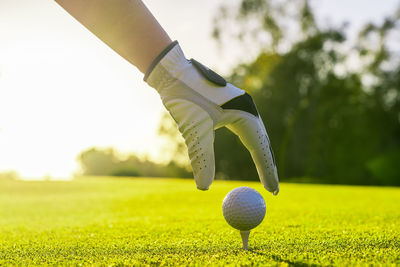 Low section of man playing golf on field