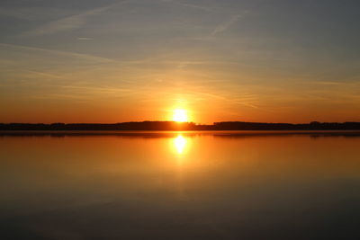 Scenic view of lake against romantic sky at sunset