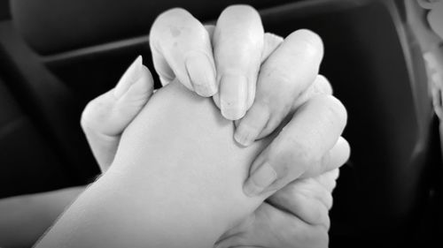 Close-up of couple holding hands