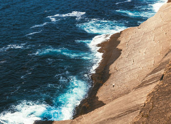 Brave old man fishing on the sea in santander, spain