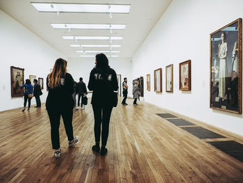 Rear view of people walking in corridor