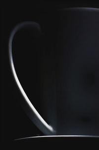 Close-up of coffee cup against black background