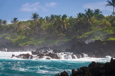 Scenic view of rough black coastline at waianapanapa state park, maui, hawaii against sky