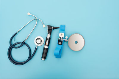 High angle view of eyeglasses on table against blue background