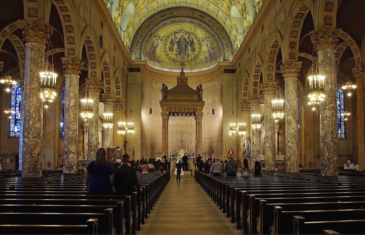 indoors, place of worship, religion, spirituality, church, illuminated, architecture, built structure, arch, famous place, tourism, travel destinations, temple - building, pew, cathedral, person, travel