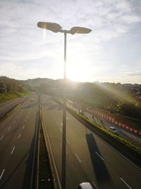 Street light by road against sky