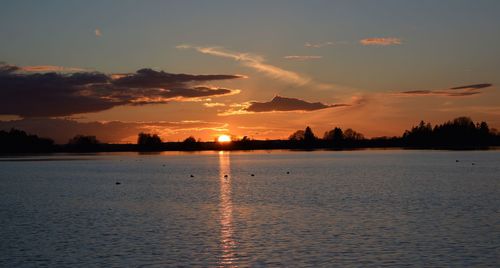 Scenic view of lake against sky during sunset