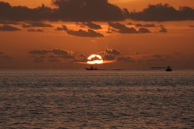 Scenic view of sea against orange sky