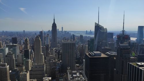 Aerial view of modern cityscape against sky