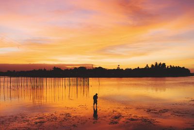 Scenic view of lake against sky during sunset