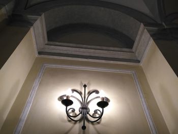 Low angle view of illuminated chandelier in building