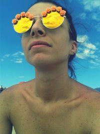 Low angle view of woman standing against sky