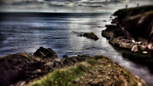 Close-up of rocks on beach against sky