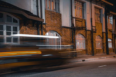 Blurred motion of illuminated street and buildings in city