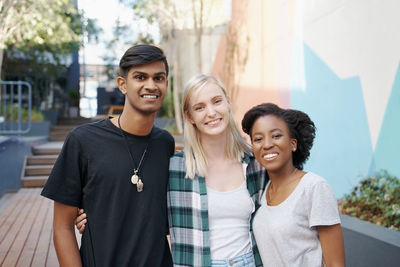 Portrait of smiling friends standing outdoors