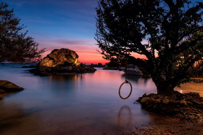 Seascape of small island by sea at dusk with twilight sky, ko man klang, rayong, thailand or siam.