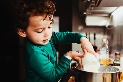 Boy holding ice cream at home