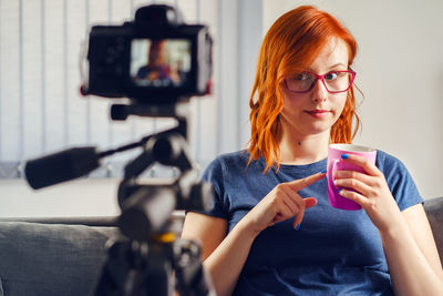 Portrait of young woman using mobile phone