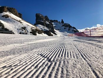 Scenic view of snowcapped mountains against clear blue sky