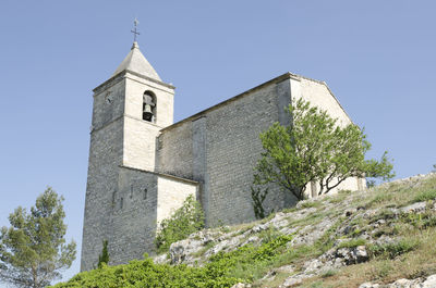 Low angle view of bell tower against clear sky