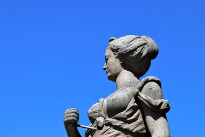 Low angle view of statue against clear blue sky