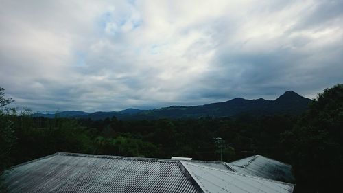Scenic view of mountains against cloudy sky