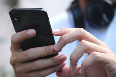 Midsection of man using mobile phone