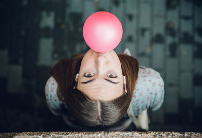 Portrait of young woman with balloons