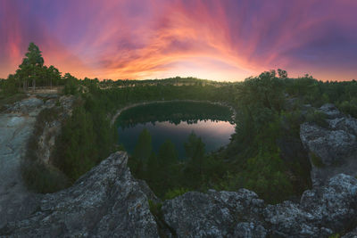 Scenic view of river against sky during sunset