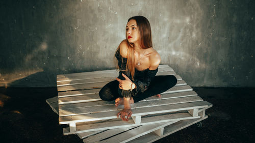 Young woman sitting on staircase