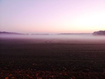 Scenic view of land against sky during sunset