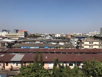 High angle view of buildings against clear blue sky