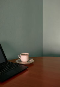 Coffee cup and a tablet on a corner table. conceptual image