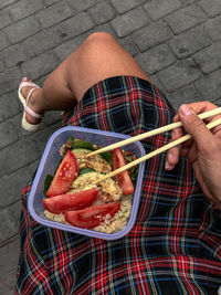 Low section of man holding food