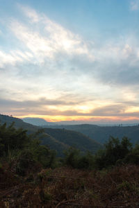 Scenic view of mountains against sky at sunset